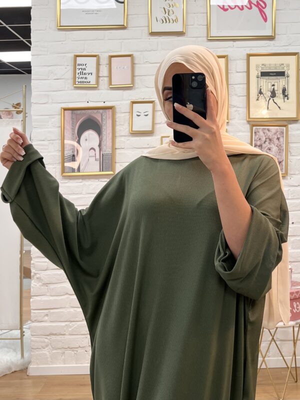 Photographie de la modèle portant le produit Abaya Papillon couleur verte de la boutique EL JAWARIYA